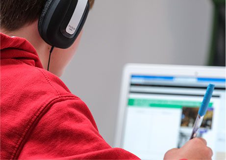 Portrait of student with headphones and laptop