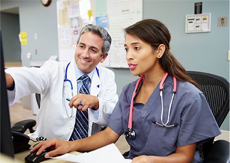 Happy smiling doctor with nurse working