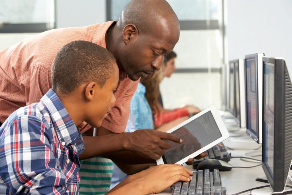 A Teacher Teaching a Child Coding