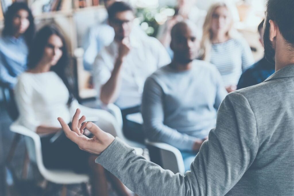 Blurry Image of a Man Talking to a Crowd